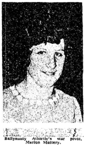 grainy black and white image of a smiling dark-haired woman